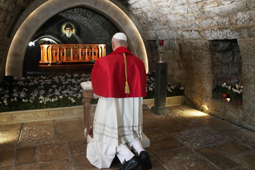 Pope Leo XIV prays in front of the tomb of St. Charbel Makhlouf at the Monastery of Saint Maroun, in Annaya, Lebanon, Monday, Dec. 1, 2025. (AP Photo/Domenico Stinellis, Pool)
