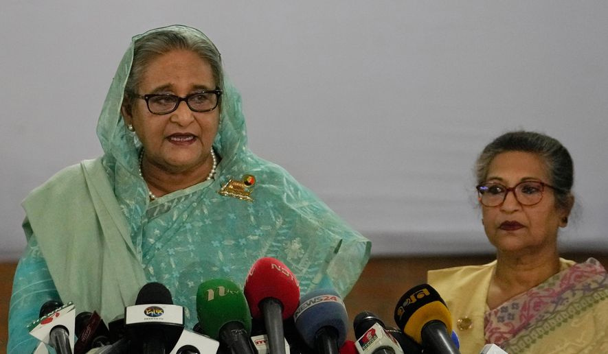 Bangladesh Prime Minister Sheikh Hasina, left, is flanked by her daughter Saima Wazed Putul, unseen, and sister Sheikh Rehana, right, as she speaks to the media after casting her vote in Dhaka, Bangladesh, on Jan. 7, 2024. (AP Photo/Altaf Qadri, File)