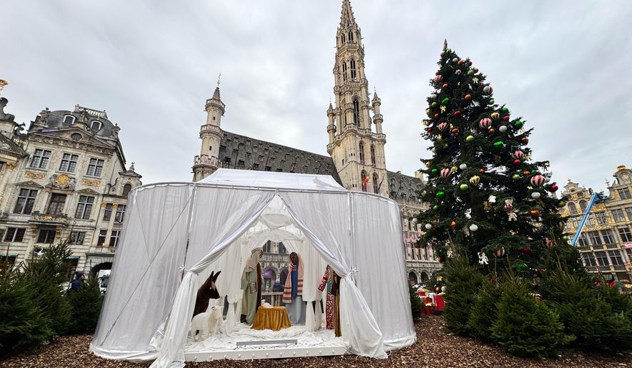 A Nativity scene containing characters with cloth faces, by Belgian artist Victoria-Maria Geyer, is displayed in a white tent in Brussels, Monday, Dec. 1, 2025. (AP Photo/Sylvain Plazy)