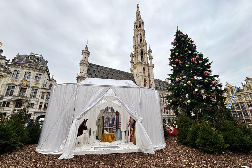 A Nativity scene containing characters with cloth faces, by Belgian artist Victoria-Maria Geyer, is displayed in a white tent in Brussels, Monday, Dec. 1, 2025. (AP Photo/Sylvain Plazy)