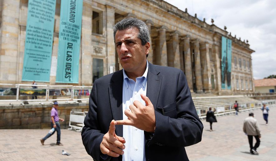 FILE - Colombian Sen. Luis Fernando Velasco talks to the press outside Congress in Bogota, Colombia, April 23, 2015. (AP Photo/Fernando Vergara, File)