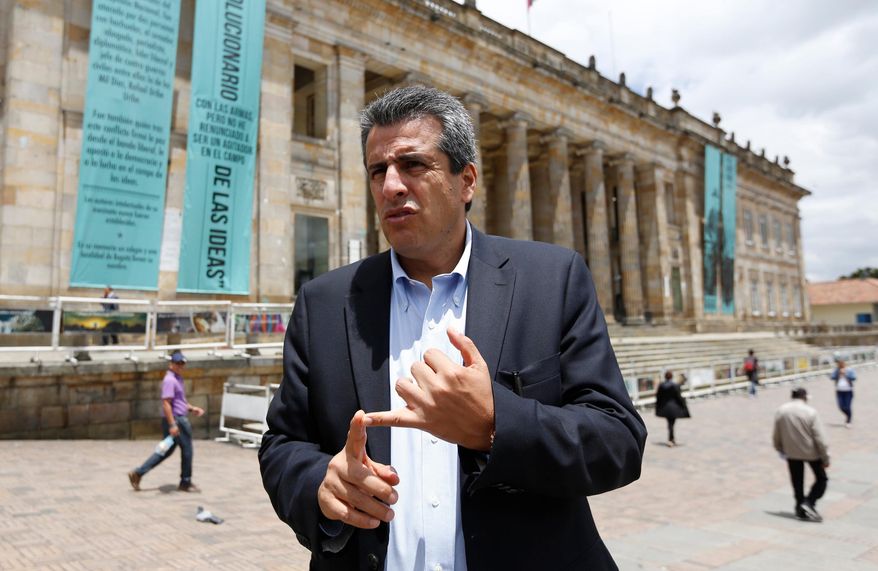 FILE - Colombian Sen. Luis Fernando Velasco talks to the press outside Congress in Bogota, Colombia, April 23, 2015. (AP Photo/Fernando Vergara, File)