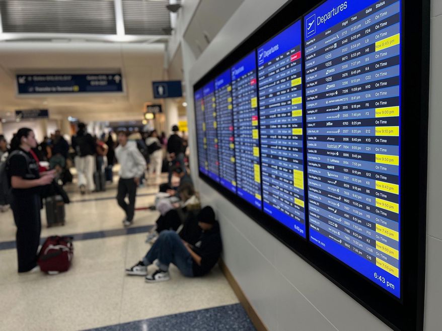 A departure board lists delayed and cancelled flights at O'Hare International Airport, Sunday, Nov. 30, 2025, in Chicago. (AP Photo/Adam Schreck)