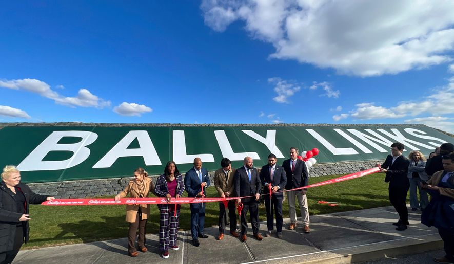 In this photo provided by the Office of the Mayor of New York, Mayor Eric Adams, third left, participates in the ribbon cutting ceremony and sign unveiling of Bally Links, formerly Trump Links, at Ferry Point in the Bronx borough of New York, Thursday, Jan. 11, 2024. (Michael Appleton/Mayoral Photography Office via AP, File)