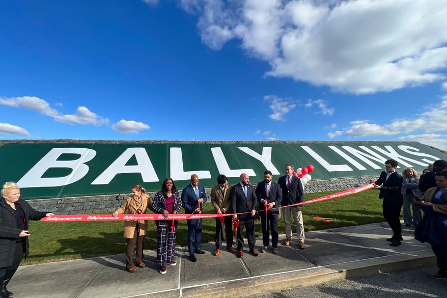 In this photo provided by the Office of the Mayor of New York, Mayor Eric Adams, third left, participates in the ribbon cutting ceremony and sign unveiling of Bally Links, formerly Trump Links, at Ferry Point in the Bronx borough of New York, Thursday, Jan. 11, 2024. (Michael Appleton/Mayoral Photography Office via AP, File)