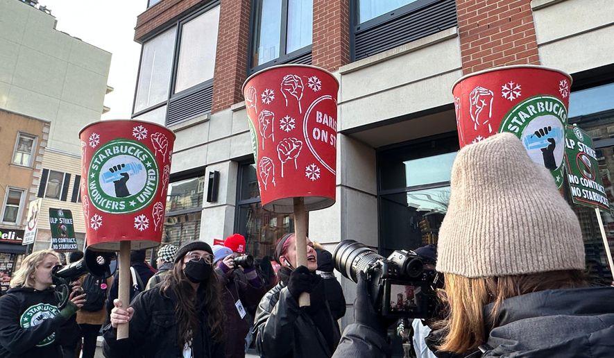 Starbucks employees and supporters picket outside a Starbucks store in the Brooklyn borough of New York, Monday, Dec. 1, 2025 (AP Photo/Jennifer Peltz)