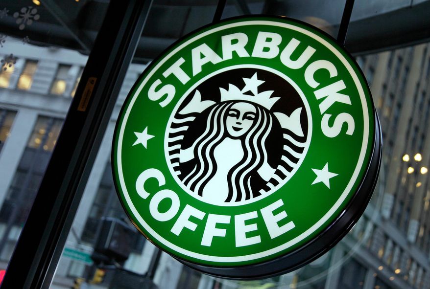 This Dec. 20, 2010, file photo shows signage at a Starbucks store in New York. (AP Photo/Richard Drew) ** FILE **