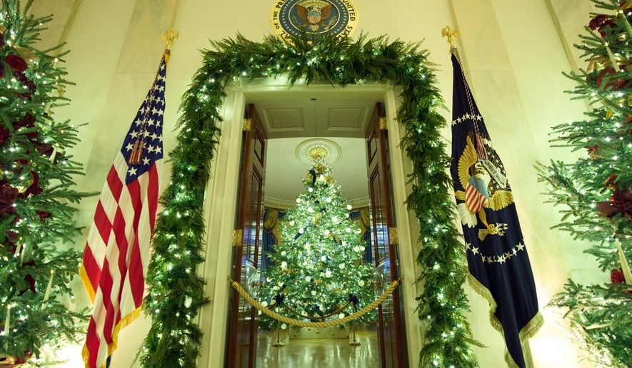 Christmas trees decorate the Cross Hall of the White House during a press preview of the Christmas decorations "Home is Where the Heart Is," Monday, Dec. 1, 2025, in Washington. (AP Photo/Evan Vucci)