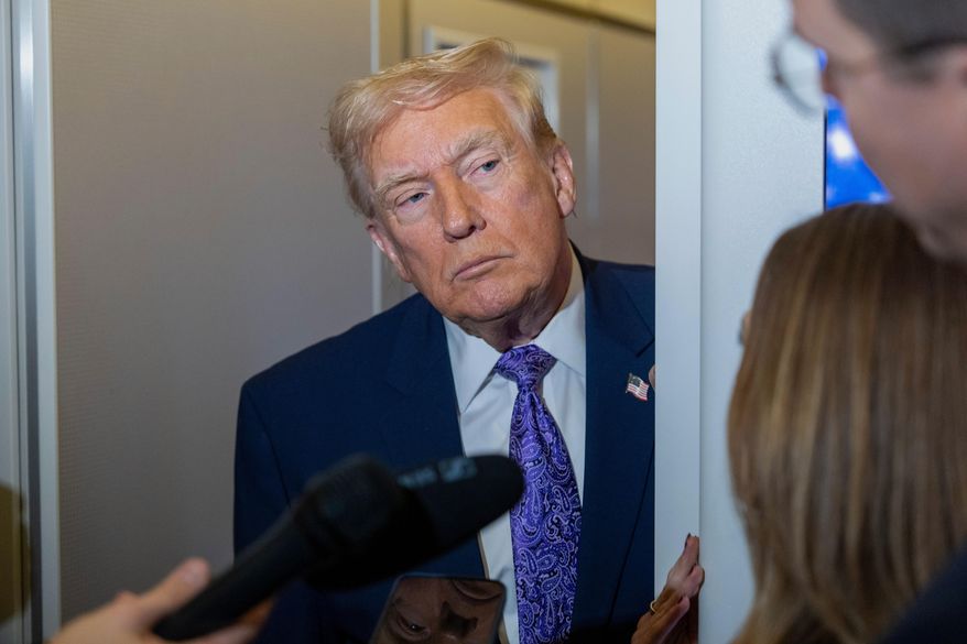 President Donald Trump speaks with reporters while in flight on Air Force One from his Mar-a-Lago estate in Palm Beach, Fla., to Joint Base Andrews, Sunday, Nov. 30, 2025. (AP Photo/Alex Brandon)