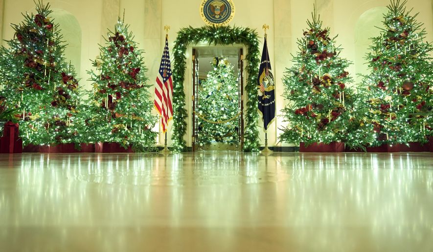 Christmas trees decorate the Cross Hall of the White House during a press preview of the Christmas decorations "Home is Where the Heart Is," Monday, Dec. 1, 2025, in Washington. (AP Photo/Evan Vucci)
