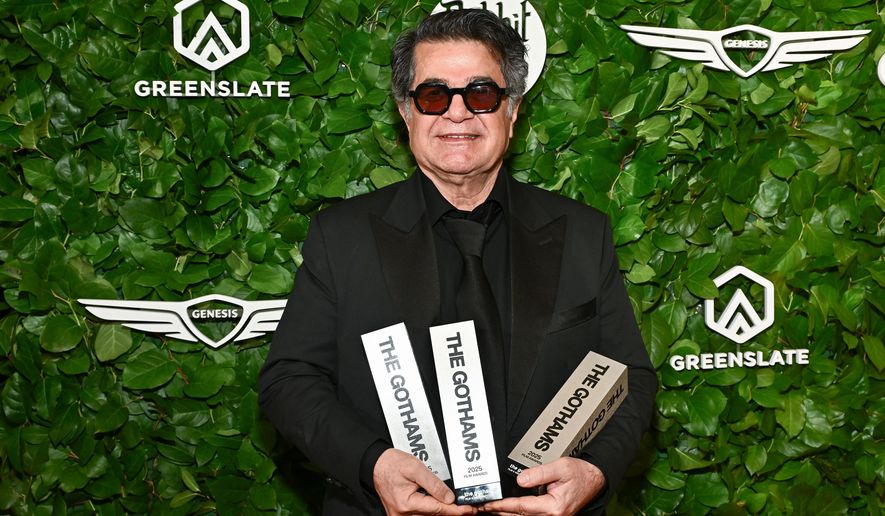 Jafar Panahi poses with the awards for best international feature, best original screenplay and best director at The Gotham Film Awards at Cipriani Wall Street on Monday, Dec. 1, 2025, in New York. (Photo by Evan Agostini/Invision/AP)
