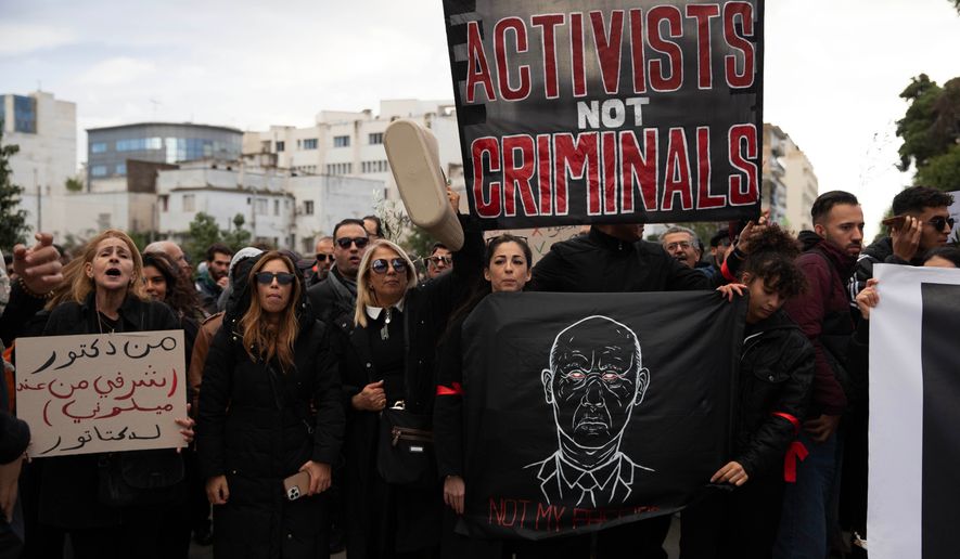 People take part in a protest against Tunisian president Kais Saied's rule and demanding the release of political prisoners in Tunis, Tunisia, Saturday, Nov. 22, 2025. (AP Photo/Anis Mili)