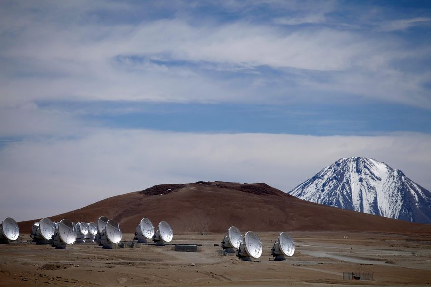FILE - Radio antennas are spread out on the terrain as part of one of the world's largest astronomy projects, the Atacama Large Millimeter/submillimeter Array (ALMA) in Chajnator in the Atacama desert in northern Chile, Sept. 27, 2012. (AP Photo/Jorge Saenz, File)