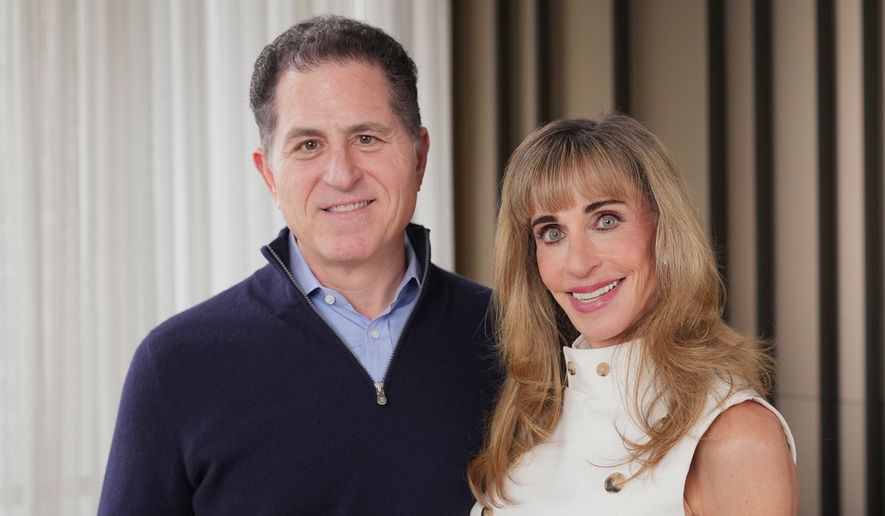 Michael and Susan Dell pose for photographs Nov. 26, 2025, in New York. (AP Photo/Frank Franklin II)
