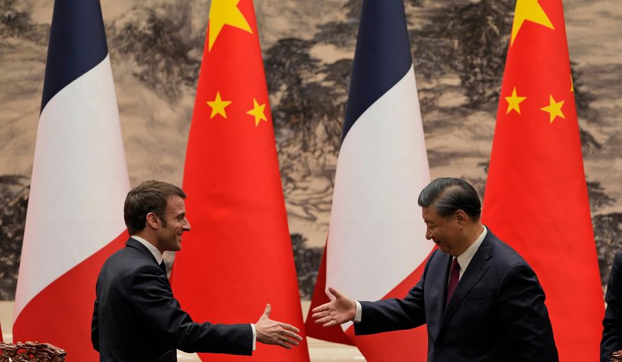 FILE - French President Emmanuel Macron, left, shakes hands with Chinese President Xi Jinping after meeting the press at the Great Hall of the People in Beijing on April 6, 2023. (AP Photo/Ng Han Guan, Pool, File)