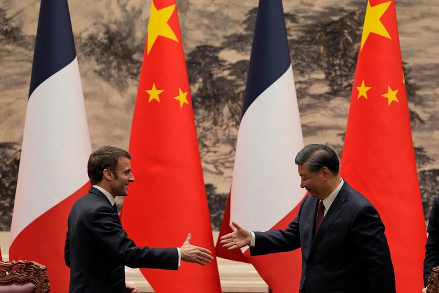 FILE - French President Emmanuel Macron, left, shakes hands with Chinese President Xi Jinping after meeting the press at the Great Hall of the People in Beijing on April 6, 2023. (AP Photo/Ng Han Guan, Pool, File)