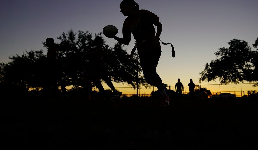 FILE - Players run drills during a practice with Texas Fury, an all-girls flag football select travel team, Dec. 10, 2023, in Austin, Texas. (AP Photo/Eric Gay, File)