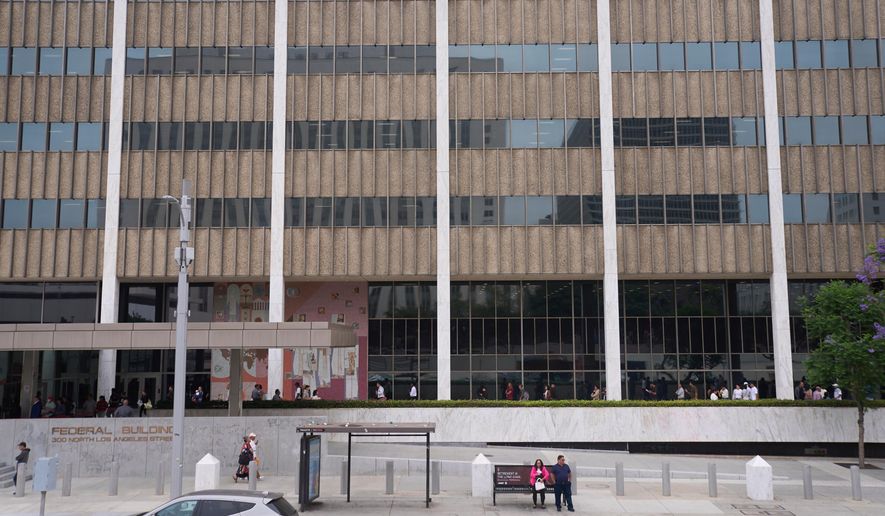 People line up outside the Los Angeles Federal Building in Los Angeles, June 25, 2025. (AP Photo/Damian Dovarganes, File)