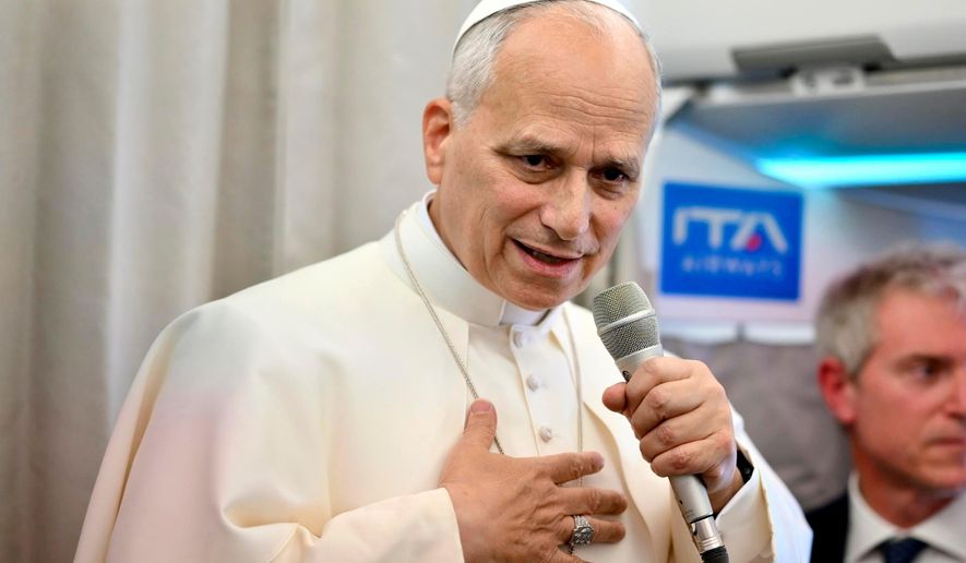 Pope Leo XIV talks to reporters aboard an airplane as he returns from a six-day visit to Turkey and Lebanon, Tuesday, Dec. 2, 2025. (Alessandro Di Meo/Pool Photo via AP)