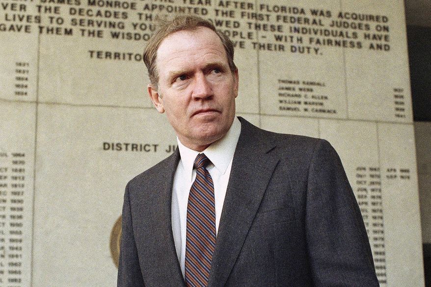Eugene Hasenfus stands outside U.S. District Court in Miami, Tuesday, Dec. 13, 1986 after appearing at a status hearing in his lawsuit against two Iran-Contra figures. (AP Photo/Kathy Willens, File)