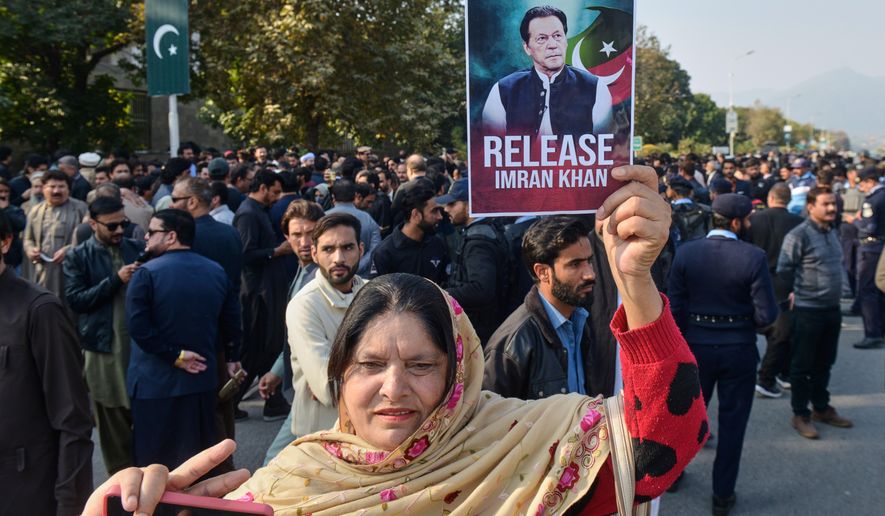 Supporter of Pakistan's imprisoned former Prime Minister Imran Khan hold a demonstration outside Islamabad High Court, in Islamabad, Pakistan, Tuesday, Dec. 2, 2025. (AP Photo/A. Sheikh)