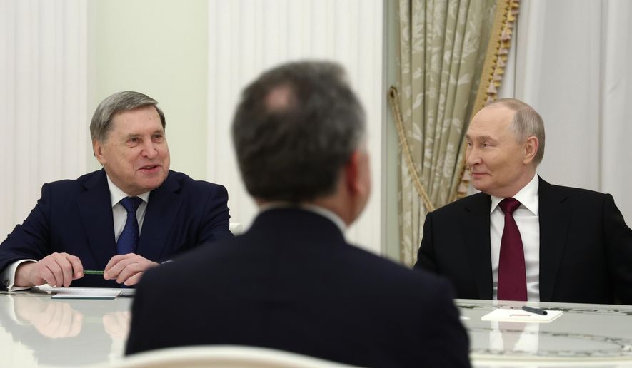 Russian President Vladimir Putin, right, and Russian Presidential foreign policy adviser Yuri Ushakov, left, attend the talks with U.S. special envoy Steve Witkoff, back to a camera, at the Senate Palace of the Kremlin in Moscow, Russia, Tuesday, Dec. 2, 2025. (Alexander Kazakov, Sputnik, Kremlin Pool Photo via AP)