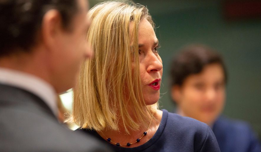European Union foreign policy chief Federica Mogherini, right, attends a meeting of EU foreign ministers at the EU Council building in Brussels, Nov. 25, 2019. (AP Photo/Virginia Mayo, File)