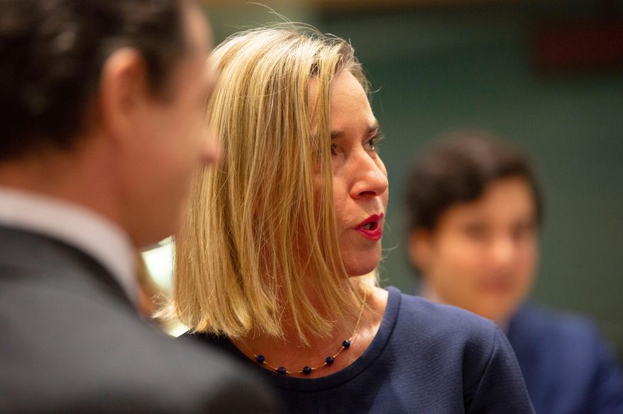 European Union foreign policy chief Federica Mogherini, right, attends a meeting of EU foreign ministers at the EU Council building in Brussels, Nov. 25, 2019. (AP Photo/Virginia Mayo, File)