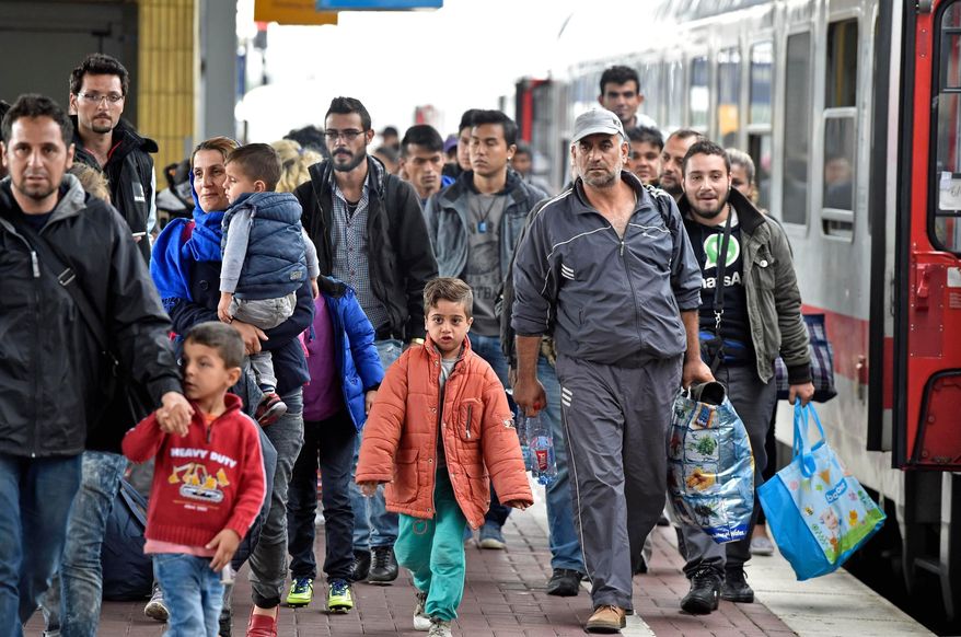 Refugees from Syria arrive at the train station in Dortmund, Germany, Sept. 6, 2015. (AP Photo/Martin Meissner, File)