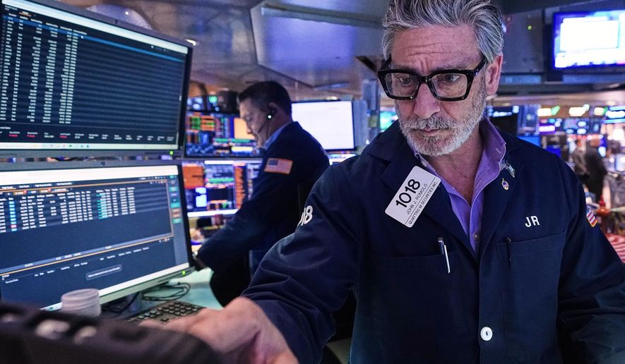 Trader John Romolo works on the floor of the New York Stock Exchange, Tuesday, Dec. 2, 2025. (AP Photo/Richard Drew)
