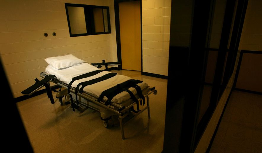 The gurney used for lethal injections sits behind glass windows in a small cinder block building at the Georgia Diagnostic and Classification Prison in Jackson, Ga., Sept. 7, 2007. (Ben Gray/Atlanta Journal-Constitution via AP, File)