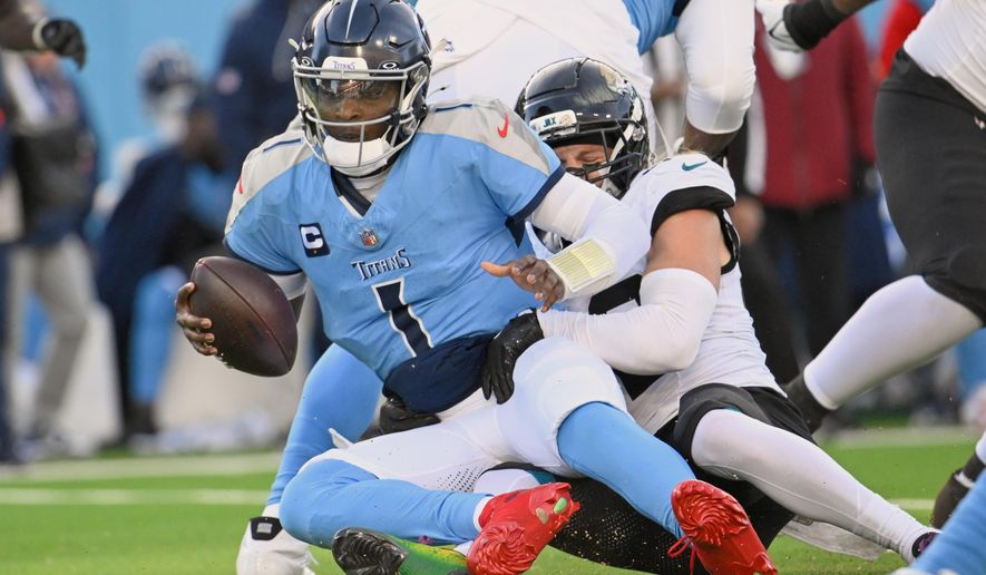 Tennessee Titans quarterback Cam Ward (1) is sacked by Jacksonville Jaguars safety Andrew Wingard during the second half of an NFL football game Sunday, Nov. 30, 2025, in Nashville, Tenn. (AP Photo/John Amis)