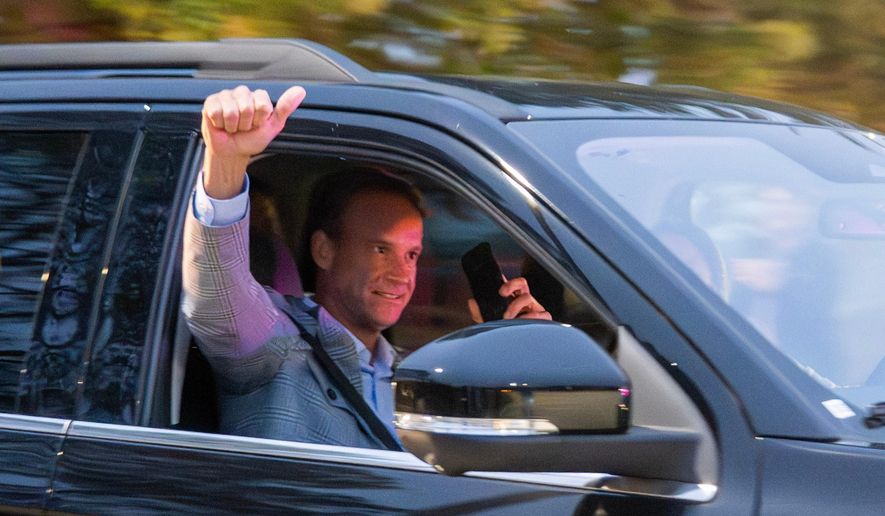 New LSU football coach Lane Kiffin pumps his fist to the crowd while leaving the MMR hanger on Sunday, Nov. 30, 2025 in Baton Rouge, La. (Michael Johnson/The Advocate via AP)