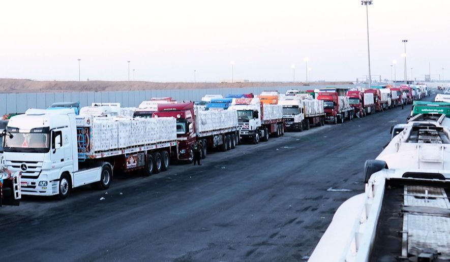 FILE -Trucks carrying humanitarian aids prepare to cross the Egyptian gate of the Rafah crossing, waiting for inspections by Israeli authorities before entering the Gaza Strip, following an agreement between Israel and Hamas on a ceasefire, Oct. 20, 2025. (AP Photo/Mohamed Arafat, File)