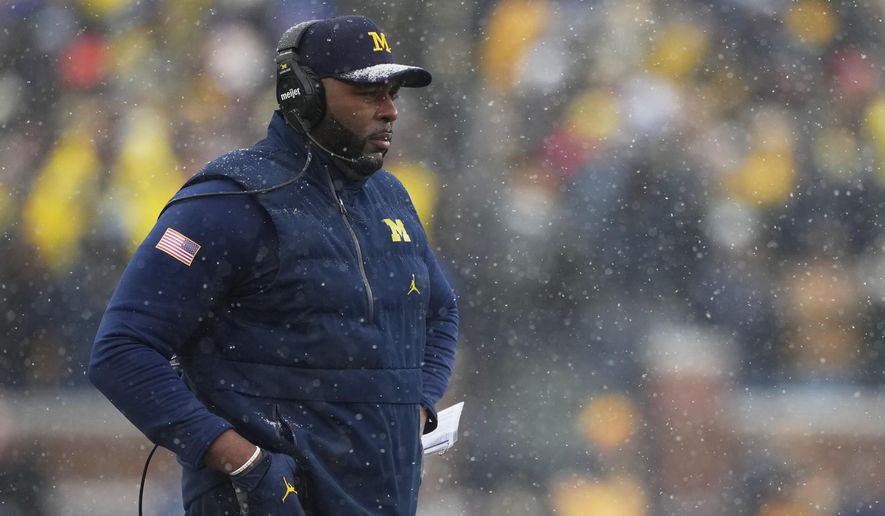 Michigan head coach Sherrone Moore watches from the sideline during the second half of an NCAA college football game against Ohio State, Saturday, Nov. 29, 2025, in Ann Arbor, Mich. (AP Photo/Ryan Sun)