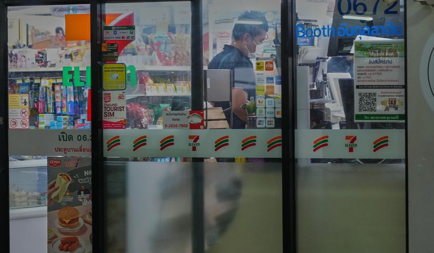 A Thai customer lines up to pay money at a convenience store in Bangkok, Thailand, Wednesday, Dec. 3, 2025. (AP Photo/Sakchai Lalit)