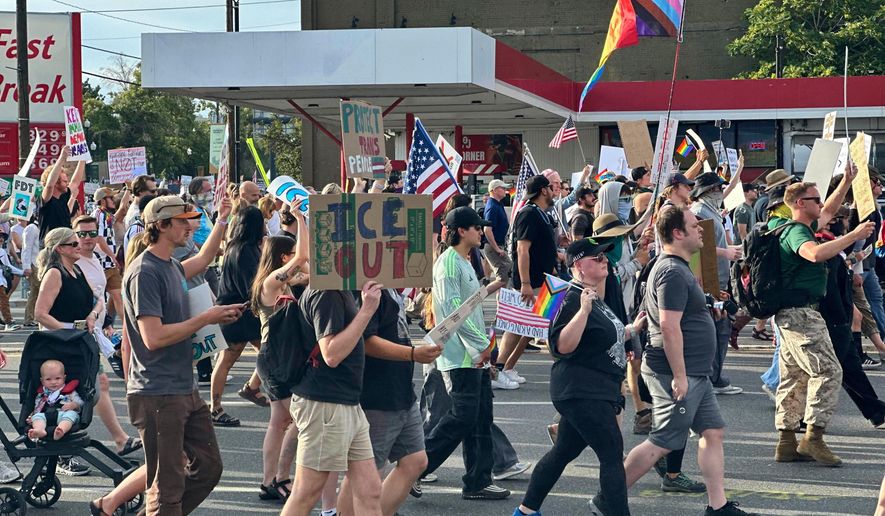 FILE - Demonstrators carry signs and chant while marching during a "No Kings" protest, June 14, 2025, in Salt Lake City. (AP Photo/Amanda Barrett, file)