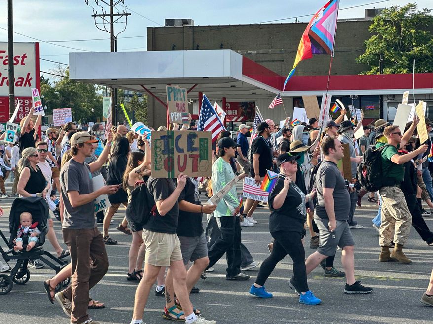 FILE - Demonstrators carry signs and chant while marching during a "No Kings" protest, June 14, 2025, in Salt Lake City. (AP Photo/Amanda Barrett, file)