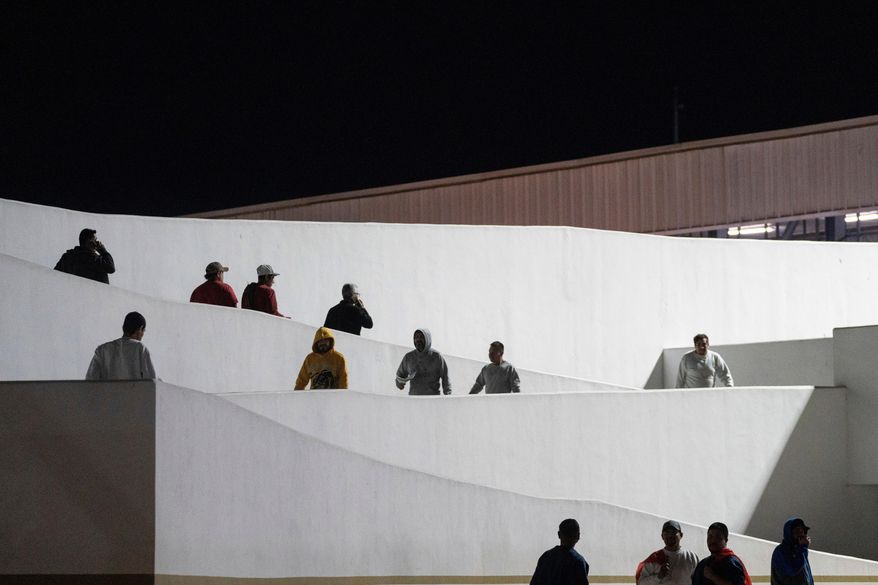 Migrants walk into Mexico after being deported from the United States at El Chaparral pedestrian border bridge in Tijuana, Mexico, on Jan. 21, 2025. (AP Photo/Felix Marquez) **FILE**