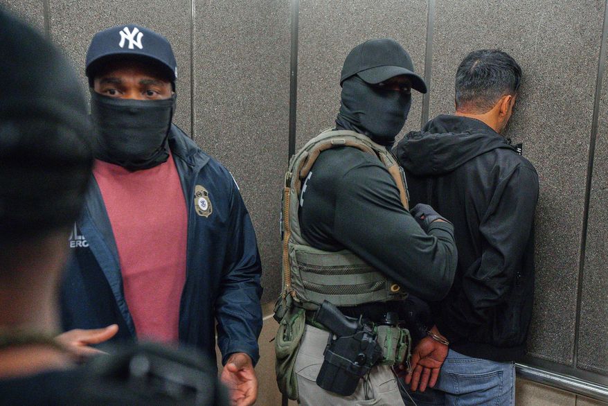 U.S. Immigration and Customs Enforcement agents escort a detained immigrant into an elevator after he exited an immigration courtroom, June 17, 2025, in New York. (AP Photo/Olga Fedorova, File)