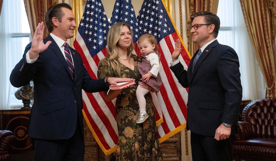 Rep. Matt Van Epps, R-Tenn, left, takes part in a ceremonial swearing-in with Speaker Mike Johnson, R-La., Thursday, Dec. 4, 2025, in Washington. Holding the Bible is Van Epps' wife, Meg Wrather, and their daughter, Amelia Van Epps. (AP Photo/Kevin Wolf)