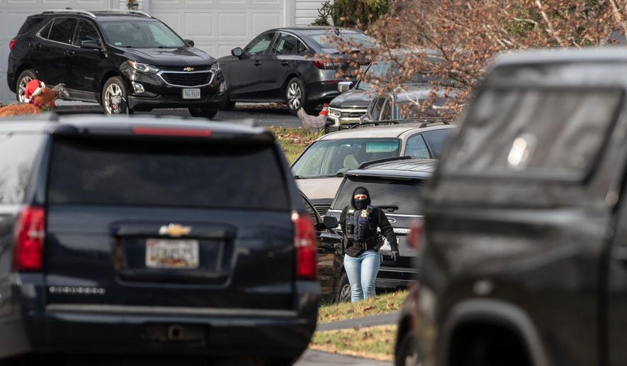 An FBI agent stands near the house where the FBI made an arrest, in Woodbridge, Va., Thursday, Dec. 4, 2025, in an investigation into who placed pipe bombs in Washington before the Jan. 6, 2021, riot at the U.S. Capitol. (AP Photo/Cliff Owen) **FILE**