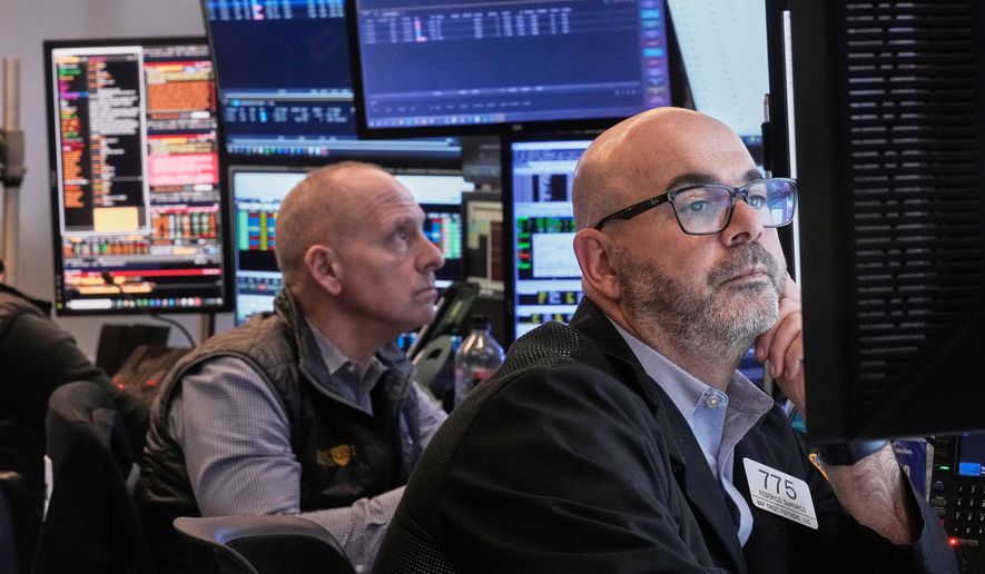 Traders Michael Urkonis, left, and Fred Demarco work on the floor of the New York Stock Exchange, Tuesday, Dec. 2, 2025. (AP Photo/Richard Drew)