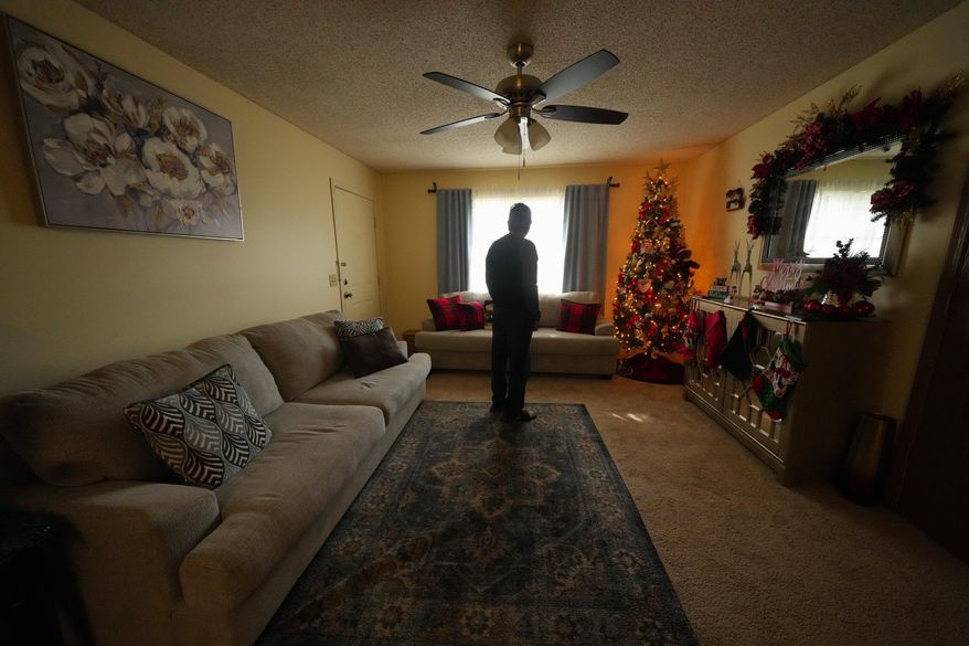 Ernesto, an immigrant from Venezuela, poses for a photograph in his home, Nov. 18, 2025, in Fayetteville, Ark. (AP Photo/Julio Cortez)