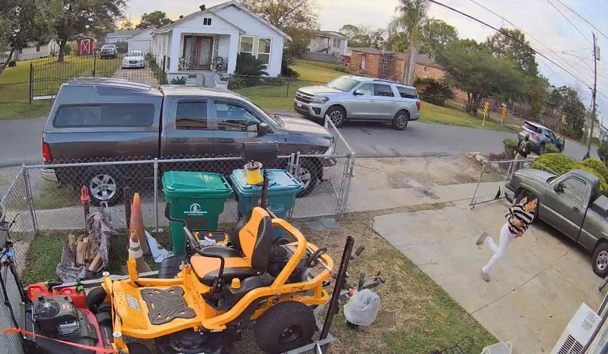 This cam footage provided by Juan Anglin shows Jacelynn Guzman, Anglin's U.S. citizen step-daughter, running from federal agents outside his home in Marrero, La., Wednesday, Dec. 3, 2025. (Juan Anglin via AP)