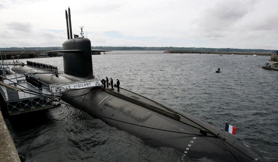 In this July 13, 2007, file photo, French Marine officers wait atop "Le Vigilant" nuclear submarine at L'Ile Longue military base, near Brest, Brittany. (AP Photo/Francois Mori, Pool, File)