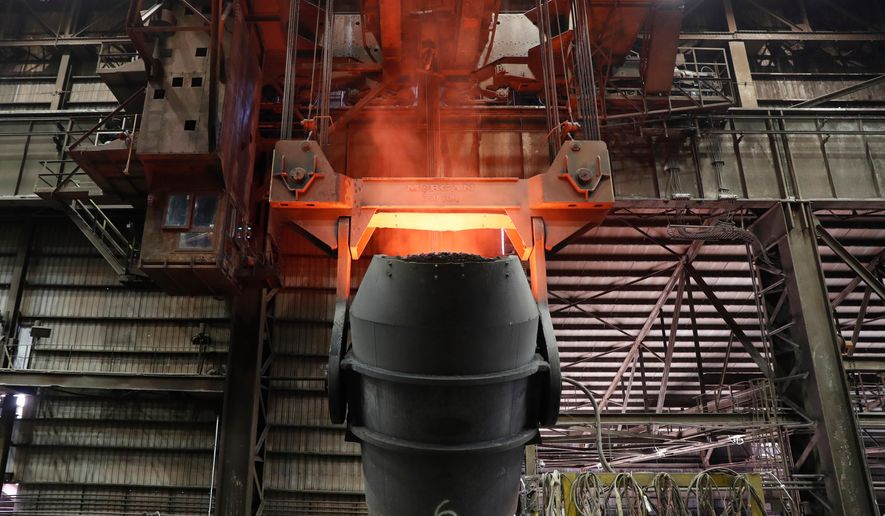 A giant ladle glows red after pouring molten iron in to a vessel inside the basic oxygen furnace as part of the processes of making steel at the U.S. Steel Granite City Works facility Thursday, June 28, 2018, in Granite City, Ill. (AP Photo/Jeff Roberson, File)