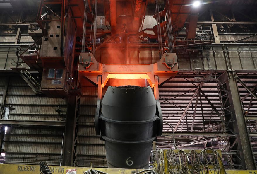 A giant ladle glows red after pouring molten iron in to a vessel inside the basic oxygen furnace as part of the processes of making steel at the U.S. Steel Granite City Works facility Thursday, June 28, 2018, in Granite City, Ill. (AP Photo/Jeff Roberson, File)