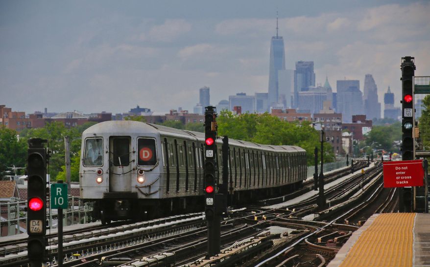 A subway approaches an above ground station in the Brooklyn borough of New York with the New York City skyline in the background, June 21, 2017. (AP Photo/Bebeto Matthews, File)