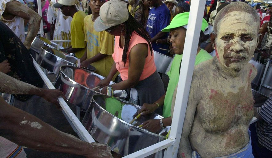 FILE -Steelpan players perform during J'Ouvert carnival celebrations in Port-of-Spain, Trinidad, Feb. 7, 2005. (AP Photo/Andres Leighton, File)